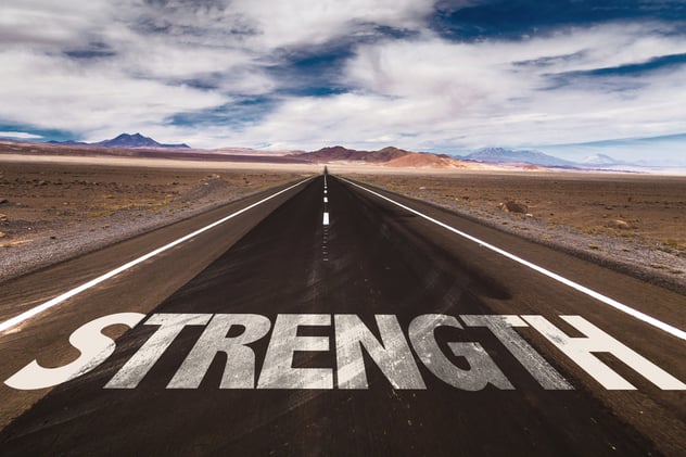Strength written on desert road