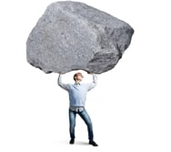 Young strong man holding huge stone above head