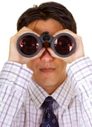businessman with binoculars over a white background - red reflection on lenses